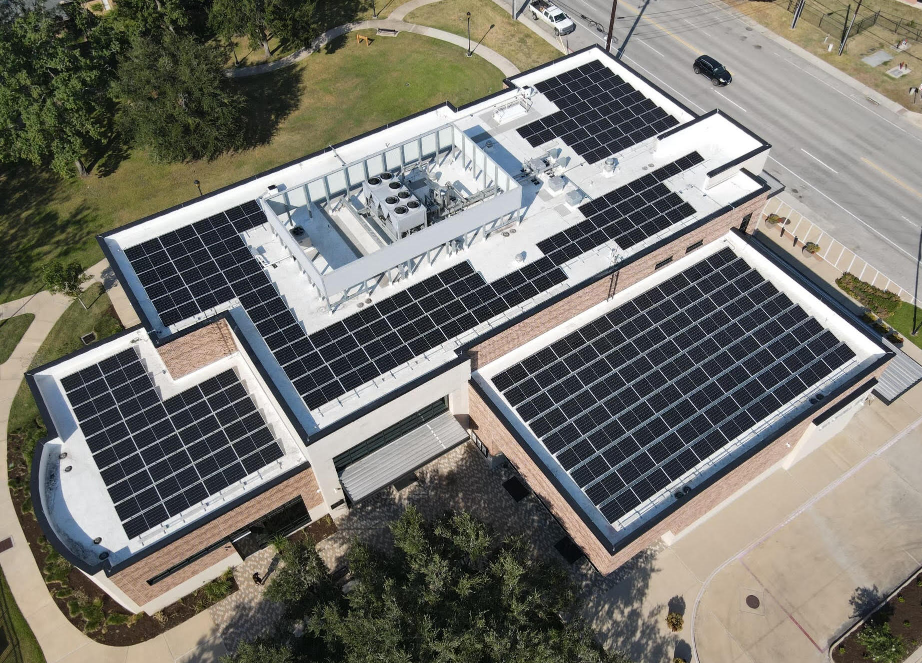 Aerial view of a commercial rooftop solar installation